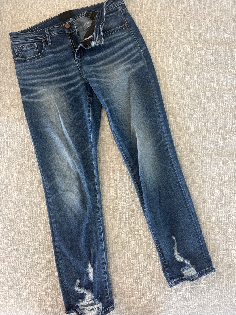 Buckle Skinny Jeans in Medium Blue Wash with Distressed Hem
